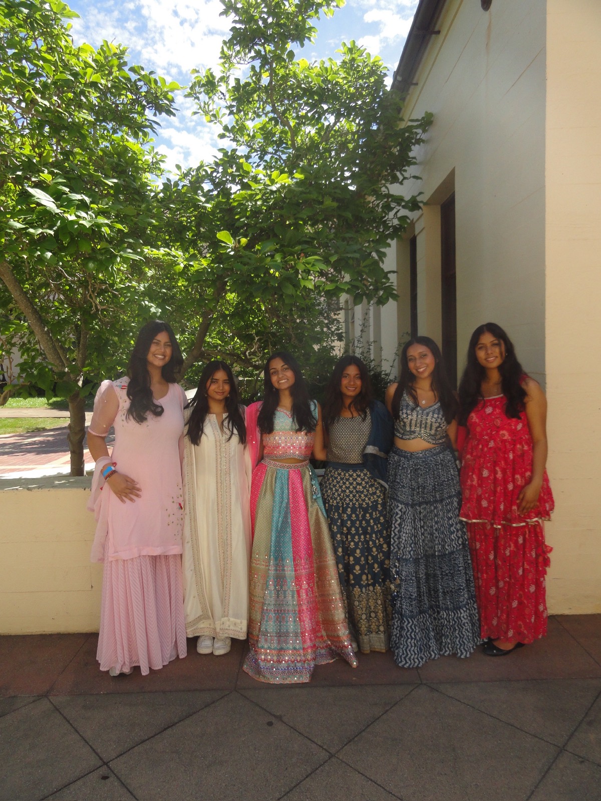 Members celebrating in traditional dress on campus